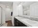 Well-lit bathroom featuring double sinks and a glass-door shower at 730 Colville Pl, Kissimmee, FL 34759