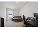 Spare bedroom featuring a convertible couch, desk space, and natural light from a large window at 730 Colville Pl, Kissimmee, FL 34759