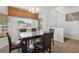 Airy dining room with a sleek table and large windows showcasing the neighborhood at 730 Colville Pl, Kissimmee, FL 34759