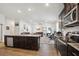 Modern kitchen with stainless steel appliances, granite countertops, and an open layout at 730 Colville Pl, Kissimmee, FL 34759