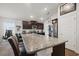 Granite kitchen island offering ample counter space and seating, perfect for entertaining at 730 Colville Pl, Kissimmee, FL 34759