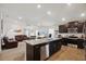 Open-concept kitchen and living area with an island, modern appliances, and seamless flow at 730 Colville Pl, Kissimmee, FL 34759