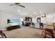 Bright, open-concept living room flows into the kitchen with bar seating and a ceiling fan at 730 Colville Pl, Kissimmee, FL 34759