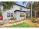 View of home exterior showing screened in patio, hardscape, and lawn at 780 Gila Dr, Kissimmee, FL 34759