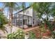 Landscaped backyard view, showing screened in patio and brick walkway at 780 Gila Dr, Kissimmee, FL 34759
