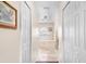 Hallway view to bathroom features tiled flooring, white cabinets, and a soaking tub at 780 Gila Dr, Kissimmee, FL 34759