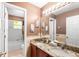 Bathroom featuring double sink vanity with granite countertop and an attached bathtub and shower at 780 Gila Dr, Kissimmee, FL 34759