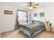 Cozy bedroom featuring a ceiling fan, carpeted floors, and an inviting atmosphere for relaxation at 780 Gila Dr, Kissimmee, FL 34759