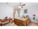 Bedroom with ceiling fan, neutral carpet, and decorative accents; creating a cozy and inviting space at 780 Gila Dr, Kissimmee, FL 34759