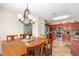Open dining area with view into the kitchen featuring stainless appliances and tile backsplash at 780 Gila Dr, Kissimmee, FL 34759