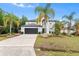 Attractive home showing palms and mulch landscaping with garage and driveway at 780 Gila Dr, Kissimmee, FL 34759