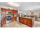 Spacious kitchen featuring granite countertops, wooden cabinets, and an island with seating at 780 Gila Dr, Kissimmee, FL 34759