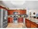 Well-lit kitchen with stainless steel appliances, wooden cabinets, and granite countertops at 780 Gila Dr, Kissimmee, FL 34759