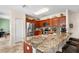 Open kitchen with granite countertop, stainless appliances, eat-in breakfast bar at 780 Gila Dr, Kissimmee, FL 34759