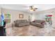 Bright living room with tile flooring, neutral walls, and sliding doors to the outdoor area at 780 Gila Dr, Kissimmee, FL 34759