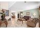 Spacious living room with tiled flooring, stylish furnishings, and dining area in the background at 780 Gila Dr, Kissimmee, FL 34759