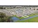 Aerial view of the neighborhood with pond; houses are closely knit with small yards and white fencing at 8243 Campbell Crossing Cir, Lakeland, FL 33810