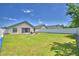 Green backyard with white fence and outdoor seating at 8243 Campbell Crossing Cir, Lakeland, FL 33810