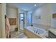 Bright bathroom with a soaking tub, glass-enclosed shower, and elegant vanity at 8243 Campbell Crossing Cir, Lakeland, FL 33810