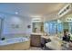 Well-lit bathroom featuring a soaking tub, shower, double vanity and stylish decor at 8243 Campbell Crossing Cir, Lakeland, FL 33810