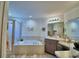 Relaxing bathroom features soaking tub, shower, and vanity with counter space and storage at 8243 Campbell Crossing Cir, Lakeland, FL 33810