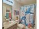 Bathroom featuring turtle themed shower curtain, decor, fixtures and vanity at 8243 Campbell Crossing Cir, Lakeland, FL 33810