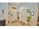 The spacious foyer has wood-look floors, a welcome sign, and access to additional rooms at 8243 Campbell Crossing Cir, Lakeland, FL 33810