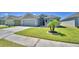 Charming single-story home with a well-maintained lawn and a two-car garage at 8243 Campbell Crossing Cir, Lakeland, FL 33810