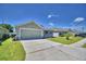 Beautiful single-story home featuring a spacious driveway and manicured lawn at 8243 Campbell Crossing Cir, Lakeland, FL 33810
