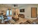Relaxing living room with backyard access, wood-look floors, and a mounted TV at 8243 Campbell Crossing Cir, Lakeland, FL 33810