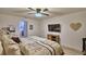 Comfortable main bedroom with a ceiling fan, television, and rustic wood accents at 8243 Campbell Crossing Cir, Lakeland, FL 33810