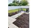 Backyard outdoor seating area, mulch, pavers, plants, enclosed with a white vinyl fence at 8243 Campbell Crossing Cir, Lakeland, FL 33810