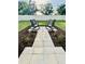 Landscaped outdoor space with seating area, pavers, mulch, and attractive plants at 8243 Campbell Crossing Cir, Lakeland, FL 33810