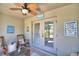 This outdoor patio has a ceiling fan, furniture, and an entrance leading to the backyard at 8243 Campbell Crossing Cir, Lakeland, FL 33810