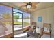 Cozy screened-in patio with ceiling fan and comfortable seating area, perfect for relaxation at 8243 Campbell Crossing Cir, Lakeland, FL 33810