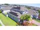 Aerial view of a neighborhood with solar panels on the roof, showcasing a sustainable home and community at 825 Grazie Loop, Davenport, FL 33837