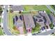 Aerial view of property with landscaped lawn, brick driveway, and neighborhood streets and homes at 825 Grazie Loop, Davenport, FL 33837