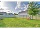 Expansive backyard with lush grass, a privacy fence, and a tree perfect for outdoor activities at 825 Grazie Loop, Davenport, FL 33837