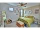 Bright bedroom featuring neutral walls, decor, carpet flooring, and natural light from a window at 825 Grazie Loop, Davenport, FL 33837