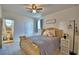 Cozy bedroom with a ceiling fan, complemented by an ensuite bathroom, offering comfort and privacy at 825 Grazie Loop, Davenport, FL 33837