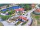 Aerial view of community entrance with decorative gate, landscaping, and the community center at 825 Grazie Loop, Davenport, FL 33837