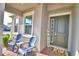 Inviting front porch featuring comfortable seating, views of the neighborhood, and a welcoming front door at 825 Grazie Loop, Davenport, FL 33837