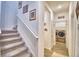 Upstairs hallway leading to the laundry room featuring a washer and dryer set at 825 Grazie Loop, Davenport, FL 33837