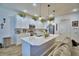 Bright kitchen featuring a center island, modern appliances, pendant lighting, and ample cabinet space at 825 Grazie Loop, Davenport, FL 33837