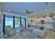 Open-concept living room and kitchen area with recessed lighting and tile floors at 825 Grazie Loop, Davenport, FL 33837