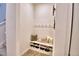 Functional mudroom area featuring a built-in bench, shoe storage, and coat hooks for organization at 825 Grazie Loop, Davenport, FL 33837
