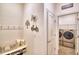 Hallway view of a well-organized mudroom and direct access into the laundry room at 825 Grazie Loop, Davenport, FL 33837