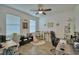This office features tile floors, two windows, a ceiling fan, and two desk spaces at 825 Grazie Loop, Davenport, FL 33837