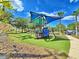 View of community playground featuring colorful equipment on a well-maintained grassy area at 825 Grazie Loop, Davenport, FL 33837