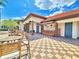 View of pool bar with seating, columns, and a decorative tiled floor and bathrooms at 825 Grazie Loop, Davenport, FL 33837